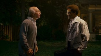 Movie still from “Norbit” (2007), directed by Brian Robbins – Two men standing next to each other in the dark; Medium shot, Over the shoulder angle