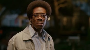 Movie still from “Norbit” (2007), directed by Brian Robbins – A person wearing glasses and a jacket; Close Up shot, Low angle