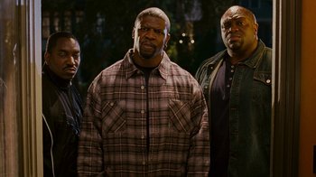 Movie still from “Norbit” (2007), directed by Brian Robbins – A group of men standing next to each other; Medium shot, High angle