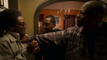 Movie still from “Norbit” (2007), directed by Brian Robbins – A group of men standing next to each other in front of a mirror; Medium shot, High angle