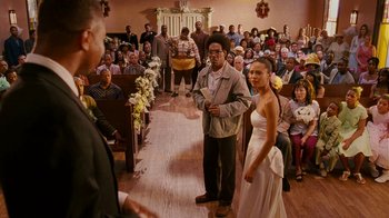 Movie still from “Norbit” (2007), directed by Brian Robbins – A couple getting married in a church with a crowd of onlookers; Wide shot, High angle