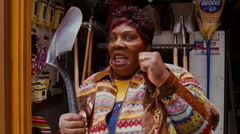 Movie still from “Norbit” (2007), directed by Brian Robbins – A woman holding a large metal spoon in her hand; Close Up shot, High angle