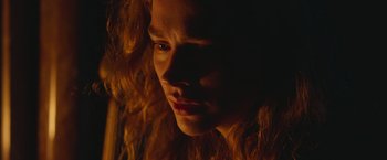 Movie still from “Mother/Android” (2021), directed by Mattson Tomlin – A person with long hair; Close Up shot, Low angle
