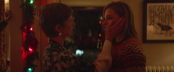 Movie still from “Mother/Android” (2021), directed by Mattson Tomlin – A woman is touching the face of another woman in front of a window; Close Up shot, Over the shoulder angle