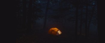 Movie still from “Mother/Android” (2021), directed by Mattson Tomlin – A tent in the middle of the woods at night; Extreme Wide shot, High angle