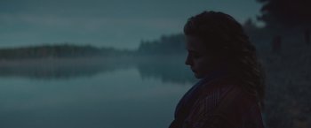 Movie still from “Mother/Android” (2021), directed by Mattson Tomlin – A man standing in front of a body of water; Close Up shot, Over the shoulder angle