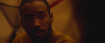 Movie still from “Mother/Android” (2021), directed by Mattson Tomlin – A man's face in the dark; Close Up shot, Over the shoulder angle