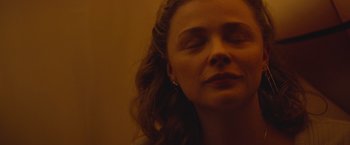 Movie still from “Mother/Android” (2021), directed by Mattson Tomlin – A person with her eyes closed; Close Up shot, Low angle