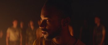 Movie still from “Mother/Android” (2021), directed by Mattson Tomlin – A person wearing a yellow shirt; Close Up shot, Over the shoulder angle