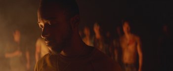 Movie still from “Mother/Android” (2021), directed by Mattson Tomlin – A person in a dark room; Close Up shot, Low angle