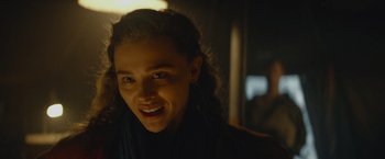 Movie still from “Mother/Android” (2021), directed by Mattson Tomlin – A person smiling for the camera; Close Up shot, Over the shoulder angle