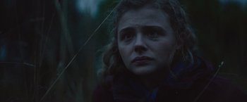 Movie still from “Mother/Android” (2021), directed by Mattson Tomlin – A young woman is looking at the camera; Close Up shot, Low angle