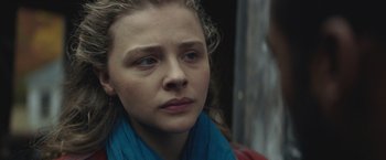 Movie still from “Mother/Android” (2021), directed by Mattson Tomlin – A person wearing a blue scarf; Close Up shot, Over the shoulder angle