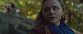 Movie still from “Mother/Android” (2021), directed by Mattson Tomlin – A person with long brown hair; Close Up shot, Over the shoulder angle