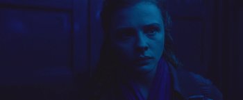 Movie still from “Mother/Android” (2021), directed by Mattson Tomlin – A person wearing a blue scarf; Close Up shot, Low angle