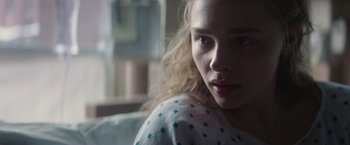 Movie still from “Mother/Android” (2021), directed by Mattson Tomlin – A young woman is looking into the camera; Close Up shot, Over the shoulder angle
