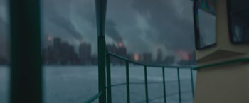 Movie still from “Mother/Android” (2021), directed by Mattson Tomlin – A view of a city from a fence; Extreme Close Up shot, High angle