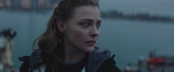 Movie still from “Mother/Android” (2021), directed by Mattson Tomlin – A person looking at the camera; Close Up shot, Over the shoulder angle