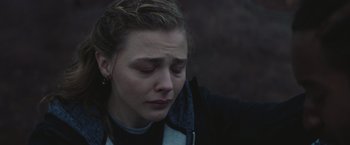 Movie still from “Mother/Android” (2021), directed by Mattson Tomlin – A young woman with her eyes closed; Close Up shot, Over the shoulder angle