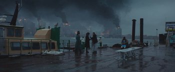Movie still from “Mother/Android” (2021), directed by Mattson Tomlin – A group of people standing on top of a dock; Extreme Wide shot, High angle