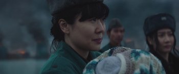 Movie still from “Mother/Android” (2021), directed by Mattson Tomlin – A woman in a green shirt is looking to her left; Close Up shot, Over the shoulder angle