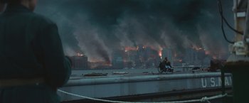 Movie still from “Mother/Android” (2021), directed by Mattson Tomlin – Two people on a bike ride in front of a large fire; Extreme Wide shot, High angle