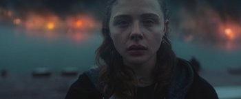 Movie still from “Mother/Android” (2021), directed by Mattson Tomlin – A young woman is looking at the camera; Close Up shot, Over the shoulder angle