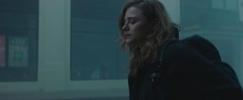 Movie still from “Mother/Android” (2021), directed by Mattson Tomlin – A woman with long brown hair standing in the dark; Close Up shot, Low angle