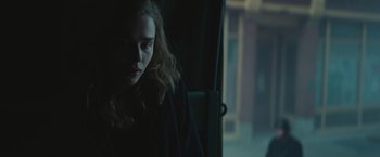 Movie still from “Mother/Android” (2021), directed by Mattson Tomlin – A woman sitting on a bus looking out the window; Close Up shot, Over the shoulder angle