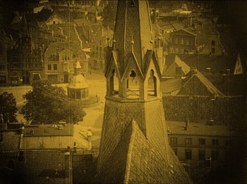 Movie still from “Nosferatu” (1922), directed by F.W. Murnau – An aerial view of an old town with a steeple; Extreme Wide shot, High angle