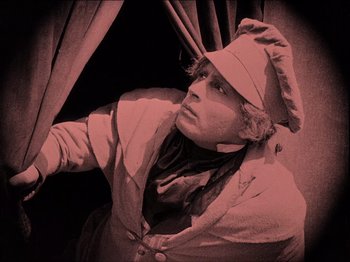 Movie still from “Nosferatu” (1922), directed by F.W. Murnau – A man wearing a white hat and a white jacket; Medium shot, Low angle