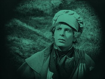 Movie still from “Nosferatu” (1922), directed by F.W. Murnau – A man wearing a hat looking up at the sky; Close Up shot, High angle