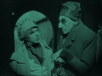Movie still from “Nosferatu” (1922), directed by F.W. Murnau – A man and a woman are standing next to each other; Medium shot, High angle