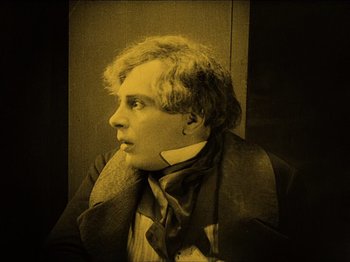 Movie still from “Nosferatu” (1922), directed by F.W. Murnau – A young man wearing a suit and a tie; Medium shot, High angle