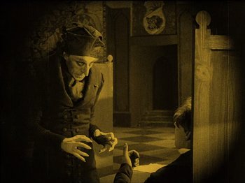 Movie still from “Nosferatu” (1922), directed by F.W. Murnau – An old photo of a woman and a boy in a room; Medium shot, High angle