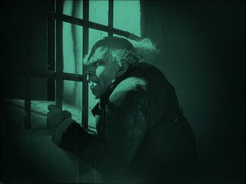 Movie still from “Nosferatu” (1922), directed by F.W. Murnau – An old man looking out of a jail cell window; Medium shot, Low angle