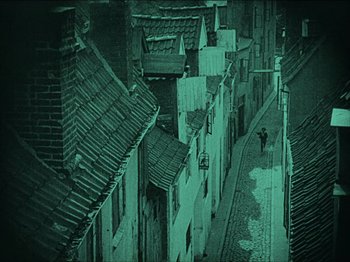 Movie still from “Nosferatu” (1922), directed by F.W. Murnau – An image of a person walking down the street at night; Extreme Wide shot, High angle