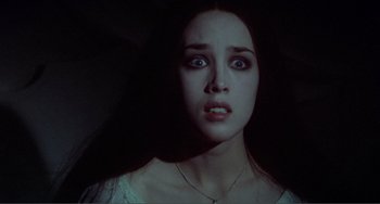 Movie still from “Nosferatu the Vampyre” (1979), directed by Werner Herzog – A young woman with blue eyes stares at the camera; Close Up shot, Low angle