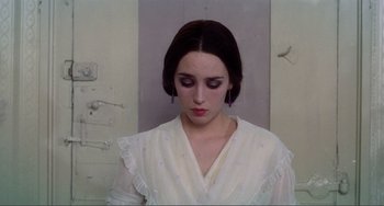 Movie still from “Nosferatu the Vampyre” (1979), directed by Werner Herzog – A woman in a white dress looking down at her face; Close Up shot, Over the shoulder angle