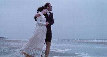 Movie still from “Nosferatu the Vampyre” (1979), directed by Werner Herzog – A man and a woman walking on the beach; Wide shot, Low angle