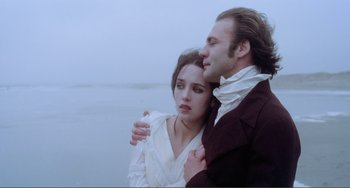 Movie still from “Nosferatu the Vampyre” (1979), directed by Werner Herzog – A man and a woman standing next to each other on a beach; Close Up shot, Over the shoulder angle
