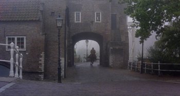 Movie still from “Nosferatu the Vampyre” (1979), directed by Werner Herzog – A person riding a motorcycle on a foggy day; Extreme Wide shot, Low angle