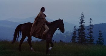 Movie still from “Nosferatu the Vampyre” (1979), directed by Werner Herzog – A man riding on the back of a brown horse; Wide shot, Low angle