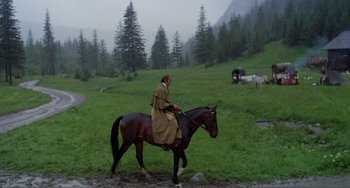 Movie still from “Nosferatu the Vampyre” (1979), directed by Werner Herzog – A man riding on the back of a brown horse; Wide shot, High angle