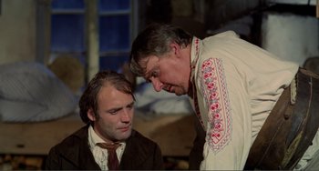 Movie still from “Nosferatu the Vampyre” (1979), directed by Werner Herzog – Two men are talking to each other while sitting down; Medium shot, Over the shoulder angle