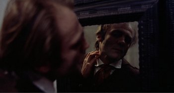 Movie still from “Nosferatu the Vampyre” (1979), directed by Werner Herzog – A man looking in a mirror while putting on a tie; Close Up shot, Over the shoulder angle