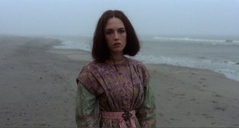 Movie still from “Nosferatu the Vampyre” (1979), directed by Werner Herzog – A woman standing on the beach wearing a dress; Medium shot, Over the shoulder angle