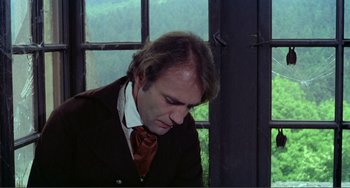 Movie still from “Nosferatu the Vampyre” (1979), directed by Werner Herzog – A man wearing a suit and tie looking down; Close Up shot, Low angle