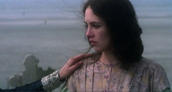 Movie still from “Nosferatu the Vampyre” (1979), directed by Werner Herzog – A young woman is touching her long dark hair; Close Up shot, Over the shoulder angle