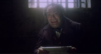 Movie still from “Nosferatu the Vampyre” (1979), directed by Werner Herzog – A man in a suit and tie holding a newspaper; Close Up shot, High angle